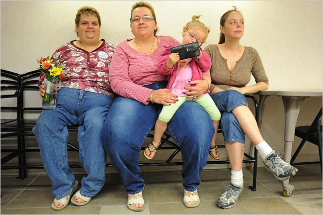 Rebecca Bird, 41, left, and Sandra Quandt, 48, waiting for a marriage license in Davenport, Iowa, on Monday with Ms. Bird’s sister, Jamie Lee, 28, and niece, Shelbie Stevens, 3.