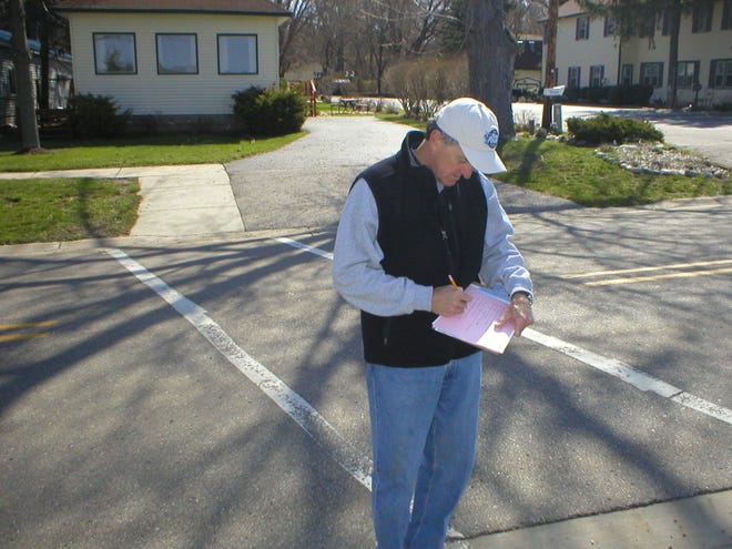 Jim Hayden/The Holland Sentinel
Jim Muir notes details about a crosswalk on Lake Street in Saugatuck Thursday, April 23, as part of the Safe Routes to School event.