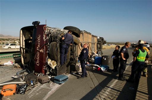 Emergency personnel work the scene of a tour bus crash Tuesday, April 28, 2009, on U.S. 101 in Soledad, Calif. (AP Photo/The Salinas Californian, Scott MacDonald)