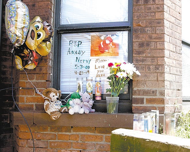 Memorials for 11-month-old Anany Sanchez sit outside the baby’s Liberty Street home in Newburgh on Tuesday. Christian Lujan of Newburgh has been accused of recklessly causing her death.