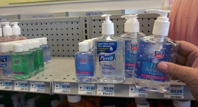 A store clerk stocks hand sanitizer on the shelf at the Rite-Aid Wednesday in Newberry. Federal health officials say there are 10 confirmed cases of swine flu in South Carolina.