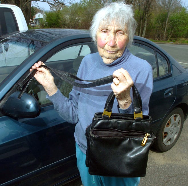 Brockton Gold Star mother Elsie Cadorette holds the pocketbook and its strap that was broken off during a struggle in her vehicle with two people who mugged her.