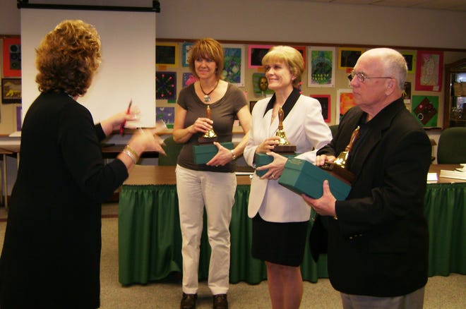 Sandi Johnson hands out golden bells Wednesday, April 29, 2009, to Connie Cywnar (left), Debbie Kerr and Jack Ramsey, who are retiring Harlem School Board members. Johnson thanked the members for their service to the board and said they will be missed.