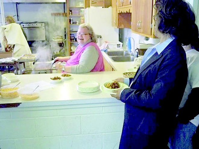 Gerry Yoneoka serves lunch to participants of the Greece Baptist Church’s “Faith in Action” day April 19. Yoneoka orchestrated the work in the kitchen, including making apple crisp, preparing dinners for the Ronald McDonald house and passing out lunch for the volunteers.