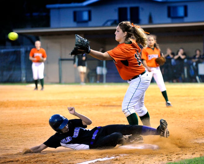 BRUCE LIPSKY/The Times-UnionFletcher's Gail Simmons (5) slides in to third safely under Mandarin's Ashlee Ellen (18) on Friday. Fletcher prevailed 3-1 in the regional semifinal game between district rivals in Neptune Beach.
