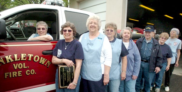 Mae Borger, president of the Kunkletown Volunteer Fire Department Ladies Auxiliary, in the driver's seat of the fire department's new brush truck. Pictured next to Borger are members of the Ladies Auxiliary who raised funds to help the fire department pay for their new vehicle.  To purchase a print of this photo, go to www.PoconoRecord.com/photostore.