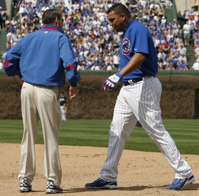 Nam Y. Huh/The Associated Press
Chicago Cubs trainer Mark O'Neal, left, talks to starting pitcher Carlos Zambrano during the fifth inning Sunday.
