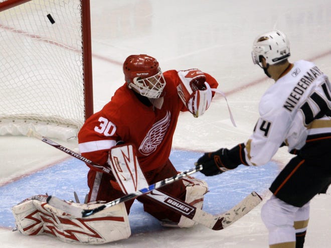 Anaheim Ducks' Rob Niedermayer (44) watches as a shot by teammate Todd Marchant goes past Detroit Red Wings goalie Chris Osgood (30) for a goal in the third overtime period of Game 2 of a second-round NHL hockey playoff series, Sunday, May 3, 2009, in Detroit. The Ducks defeated the Red Wings 4-3. (AP Photo/Detroit Free Press, Kirthmon Dozier) ** THE DETROIT NEWS OUT NO SALES **