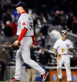 Boston Red Sox closer Jonathan Papelbon reacts after New York Yankees' Robinson Cano struck out with the bases loaded for the final out of the Red Sox's 6-4 victory over the Yankees in a baseball game at Yankee Stadium in New York, Tuesday, May 5, 2009. The Yankees' Brett Gardner is on third base, right. (AP Photo/Kathy Willens)
