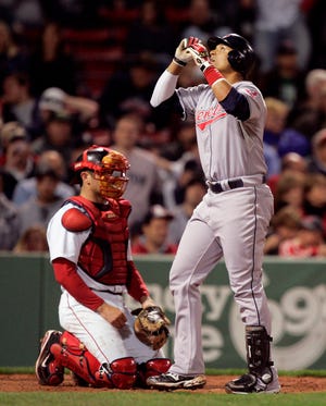 The Indians' Victor Martinez looks up in front of Red Sox catcher Jason Varitek as he crosses the plate after hitting a home run in the ninth inning of the Sox' 9-2 loss on Wednesday night.