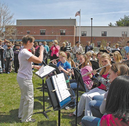 Laurie Ellis leads the Middle School of the Kennebunks band during the re-dedicaion of the Pink Ribbon Garden at the school. The garden was created in honor of Ellis, who has been cancer-free for two years.