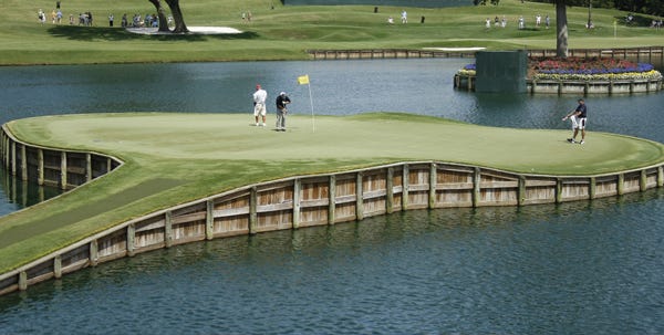 Tom Pernice Jr., center, putts on the 17th green during the a practice round at the Players Championship golf tournament at The TPC Sawgrass in Ponte Vedra Beach, Fla., Tuesday, May, 5, 2009. (AP Photo/J Pat Carter)