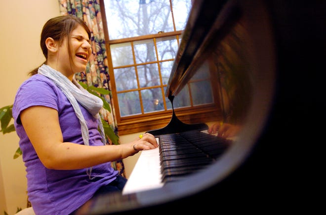 Kidney transplant recipient, 11 year old Ariana Kershenbaum belts out a Beatles tune "Let it be" during a rehearsal at her North Andover home. Her sisters Liz and Ayelet will be backing her up during a Share the Beat, a American Society of Transplantation and the Redford Family, fundraising event May 30, 2009 at Symphony Hall.
