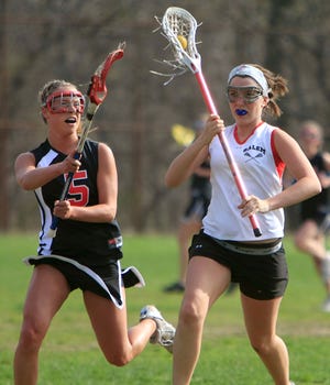 Marblehead defenseman Meg McDonald (#5) defends against Salem's Abbey Noone during the first half of their game on Thursday, April 30 at Salem High School.