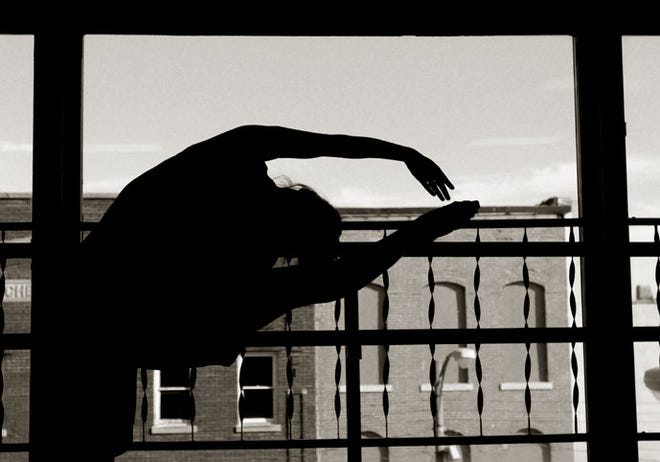 Dancer Chelsea Brown stretches before rehearsals Thursday evening at the S&R Dance studio on Stephenson Street.