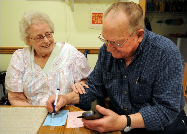 Adeline and Chester Patyk of Plymouth, Minn., log their weight at home.