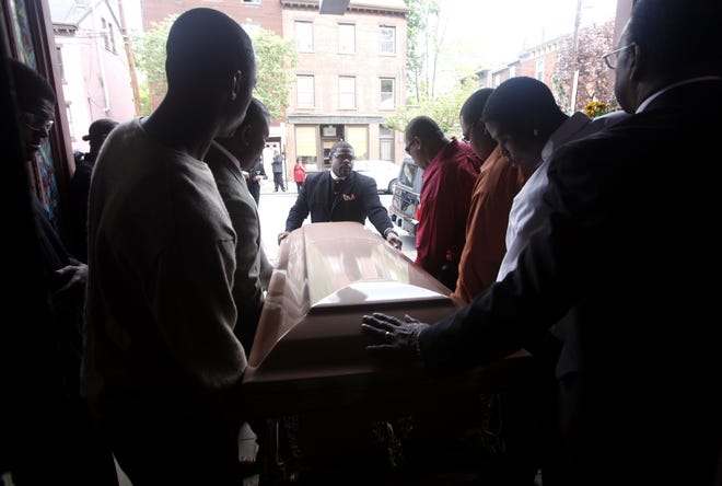Pallbearers guide Tyrik Omar Legette’s casket from the House of Joy Church after his funeral in Newburgh on Friday. Legette, 34, was stabbed to death on Lander Street by a group of youths April 30. He was the 10th person killed in 16 months in the city.