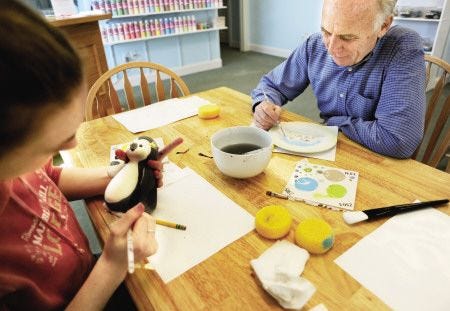 Melissa Hanley of York paints with her grandfather Roger Bean of Kittery, at Naked Plates, a newly open paint your own pottery studio on Route 1 in York.