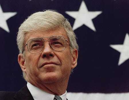 In this 1996 photo, Republican vice presidential hopeful Jack Kemp looks out over a crowd gathered for a rally in Russell, Kan., as Republican presidential hopeful Bob Dole introduces him as his running mate.