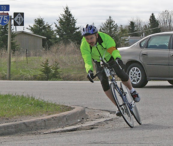 Tom Piippo, of Rudyard, rounds the corner of M-48 and Mackinac Trail in Rudyard during the inaugural “Tag” Time Trial on Saturday morning. Piippo rode the 12.7-mile course finishing first with a time of 33 minutes, 25 seconds. The event raised funds for the Lance Armstrong Foundation to fight cancer.