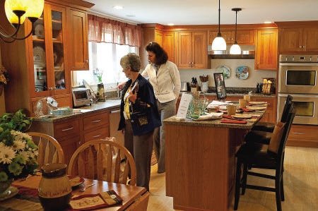 Guests of the Exeter Kitchen Tour examine detail in the Holmes’ home kitchen on Park Street on Saturday.