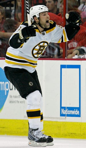 Boston Bruins' Marc Savard celebrates his goal against the Carolina Hurricanes during the second period of Game 6 of an NHL hockey Eastern Conference semifinal series in Raleigh, N.C., Tuesday, May 12, 2009. (AP Photo/Gerry Broome)