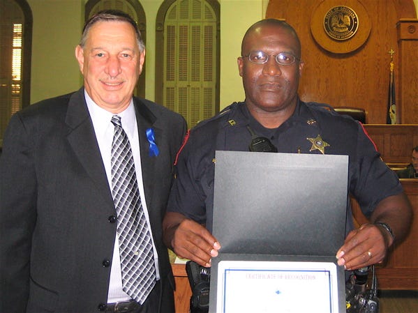 Ascension Parish Deputy Dwight Wright, right, received a parish certificate of recognition from President Tommy Martinez during last month’s parish council meeting in Donaldsonville. Wright was chosen as “Ascension Parish Deputy of the Year” by the Ascension Parish Sheriff’s Office.