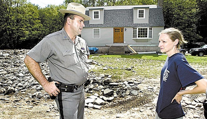 Trooper Joe Decker meets with Robin Francisco at her Town of Colchester home in August. Decker saved her family.