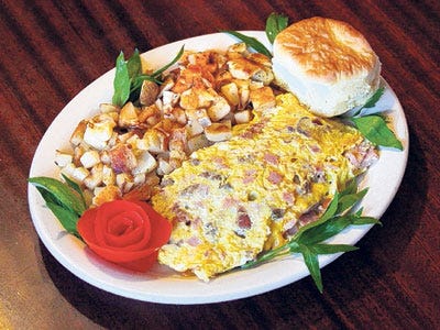 The Meat-Lover's Omelet at Mike's Grill in Bartow is served with home fries and a biscuit.