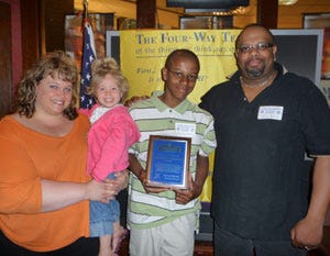 Brandon Herring is flanked by his family as he accepts the Lake-Green Rotary Club student of the month award.