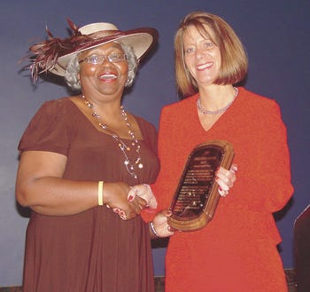 Elizabeth O’Dell, president of the Three Rivers chapter of the NAACP, receives the 2009 Liberty?Bell Award from Laurie Hines, president of the St. Joseph County Bar Association.