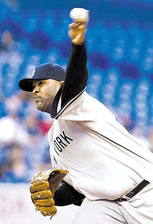 New York Yankees starting pitcher CC Sabathia delivers to the Toronto Blue Jays during second-inning AL baseball game action in Toronto on Thursday, May 14, 2009. (AP Photo/The Canadian Press,Frank Gunn)