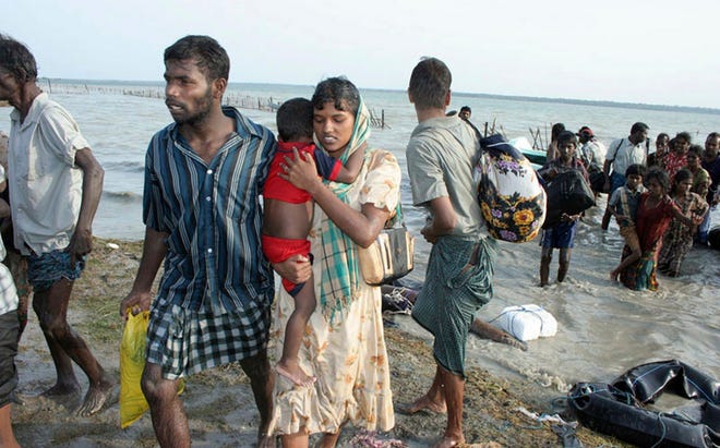 Internally displaced ethnic Tamil civilians reach a government control area after crossing a lagoon in Vellamullivaikal, Sri Lanka.SRI LANKAN ARMY