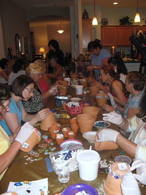 ABOVE: Jewish Women's Circle members met to decorate flower pots as a pre-Shavuot celebration. LEFT: