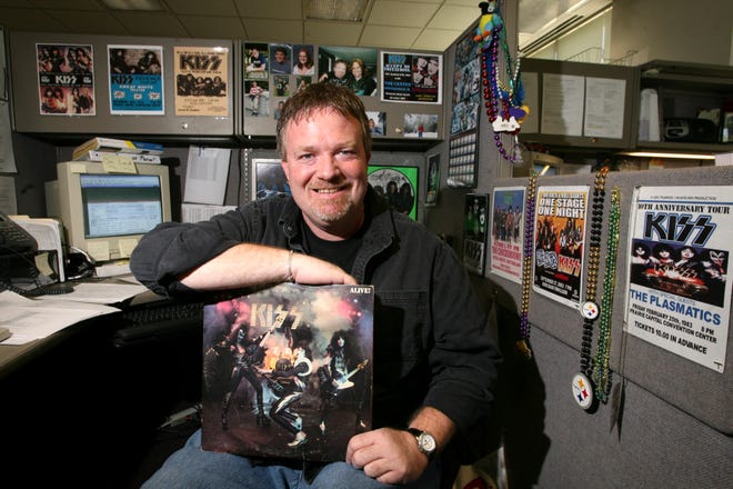 Mike Austin's love for the band KISS is evident from his office cubicle. The band’s double LP “KISS Alive” was his first album. “Just the cover on the front was enough to make you want to buy it,” he says. T.J. Salsman/The State Journal-Register