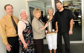 (L-R) Cal Wescott, chair of Freeport Downtown Development Foundation, Carole Dickerson, co-chair of Soup-er Friday, Marg Blum, promotions chair of Freeport Downtown Development Foundation hands Millie Keith, chair of Freeport Noon Kiwanis Club the trophy for having the winning entry of Chicken Gnocchi Soup from her personal collection and Dan Streeb, owner of Waves...the Salon, sponsor site for Soup-er Friday and host location for Freeport Noon Kiwanis.