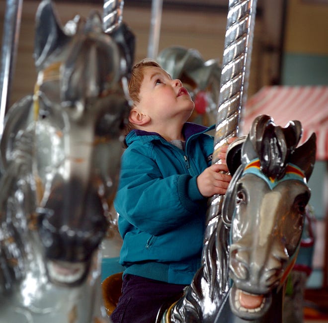 The Paragon Carousel at Nantasket Beach opened for the season in 2007. Four-year-old Harry Peter of Hull rides a horse on the carousel as it spins around.