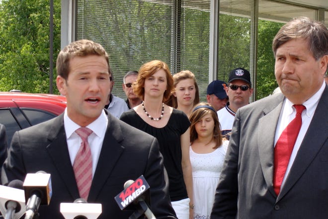 U.S. Congressman Aaron Schock, left, speaks out Sunday at a press conference on the pending closing of Uftring Chrysler in North Peoria. Looking on is Grary Uftring.