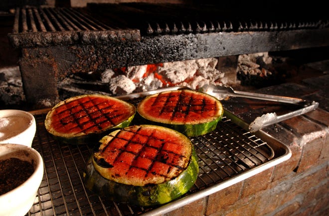 Photos by BRUCE LIPSKY/The Times-Union Watermelon grilled over a mesquite fire will be paired with bacon-wrapped shrimp and served as an appetizer at Eleven South Bistro in Jacksonville Beach. The restaurant's chef, Eric Streets, sprays the melon with oil and seasons it with salt before grilling it.