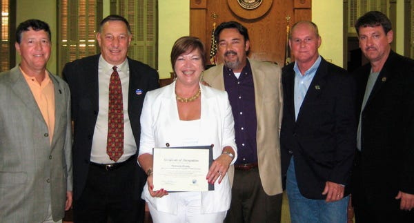 Ascension Parish Schools Assistant Superintendent Patrice Pujol was recognized at the parish council meeting May 7 for her recent nomination in the Education and Research Category of the “Louisiana Legislative Women’s Caucus 2009 Awards.” Pujol, third from left, received a parish certificate of recognition. Also shown from left are Councilman Kent Schexnaydre, President Tommy Martinez, Tim Pujol, Councilman Randy Clouatre and Councilman Dempsey Lambert.