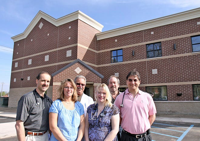 The doctors of Riverside Medical and the owners of Arfstrom Pharmacies, Inc. pause outside their recently completed Heritage Building at 601 Osborn. The new building expands the area for Riverside Medical offices and Sault Community Pharmacy, and offers additional space for other medical-related businesses. On hand Wednesday were (from left) Dr. Robert Mackie, Jeanine LaCross, Dr. Timothy Tetzlaff, Dr. Amy Postma, Don Corbiere and Dr. John Ockenfels.