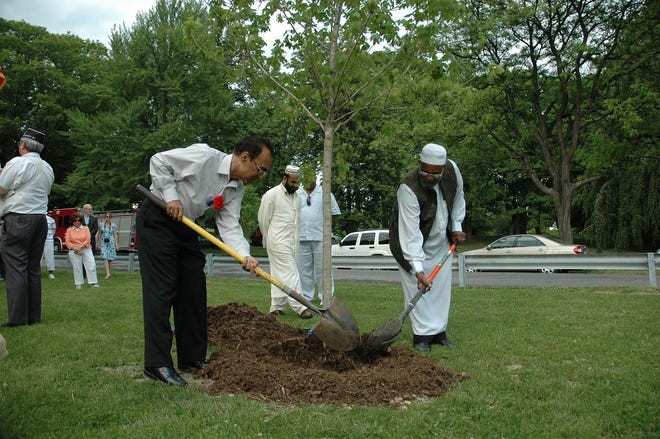 Nazar Naqvi, father of 1st Lt. Mohsin Naqvi, and Imam Muhammad Salahuddin help to plant a tree in memory of Naqvi, who was killed 8 months ago while serving his country in Afghanistan.