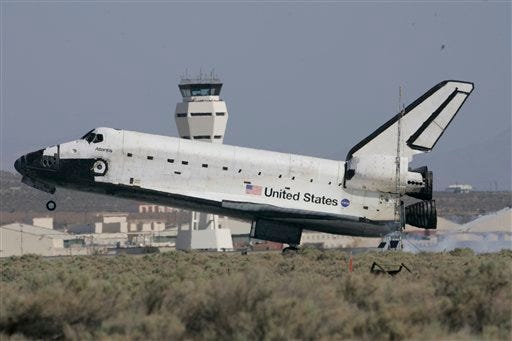 The space shuttle Atlantis touches down at the NASA Dryden Flight Research Center at Edwards Air Force Base, Calif., at the conclusion of mission STS-125 to repair the Hubble space telescope, Sunday, May 24, 2009. (AP Photo/Reed Saxon)