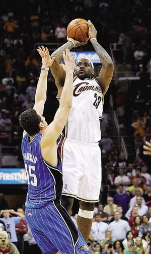 Cleveland Cavaliers' LeBron James (23) makes a 3-point shot over Orlando Magic's Hedo Turkoglu (15), from Turkey, as time expired to give the Cavaliers a 96-95 win in Game 2 of the NBA Eastern Conference basketball finals Friday, May 22, 2009, in Cleveland. (AP Photo/David Richard)