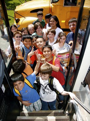 North Boone Upper Elementary School students line up to board their school bus Thursday, May 21, 2009, after class.