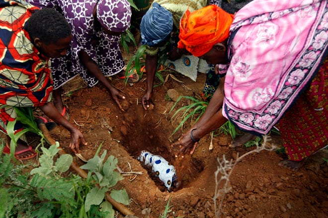 A stillborn baby, delivered at a hospital with shortages of doctors, drugs and equipment, is buried in Berega, Tanzania. "We lost four or five babies this week," said the Rev. Isaac Y. Mgego, an Anglican priest and the hospital's director. "Our doctors have to play with two bad things, to save the mother or save the child."NEW YORK TIMES / BEATRICE DE GEA