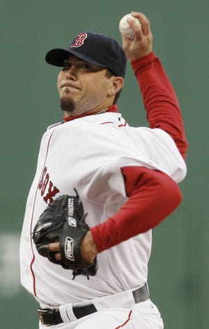 Boston Red Sox pitcher Josh Beckett delivers against the New York Mets during the first inning of a baseball game at Fenway Park in Boston Saturday, May 23, 2009. (AP Photo/Winslow Townson)