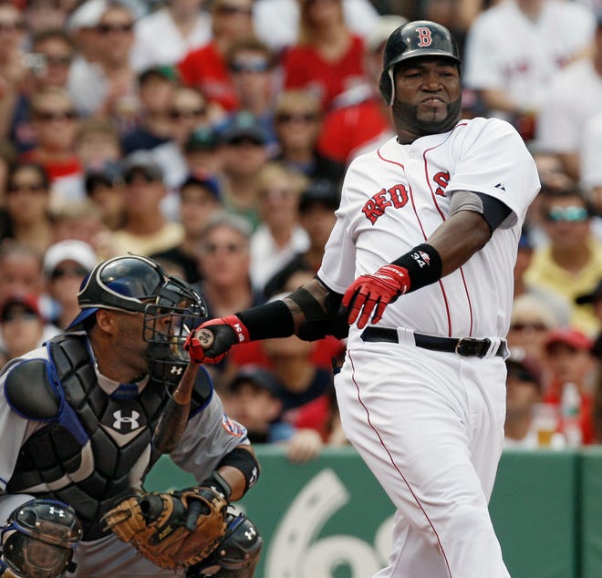 David Ortiz swings and misses and hits New York Mets catcher Ramon Castro's mask during the Red Sox 12-5 win.