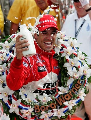 Helio Castroneves, of Brazil, douses himself with milk after winning the Indianapolis 500 auto race at Indianapolis Motor Speedway in Indianapolis, Sunday, May 24, 2009. (AP Photo/Michael Conroy)
