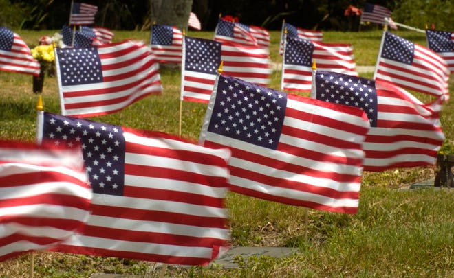 Flags fly over the graves of veterans at Gulf Pines Memorial Park in Englewood. HERALD-TRIBUNE ARCHIVE / 2007